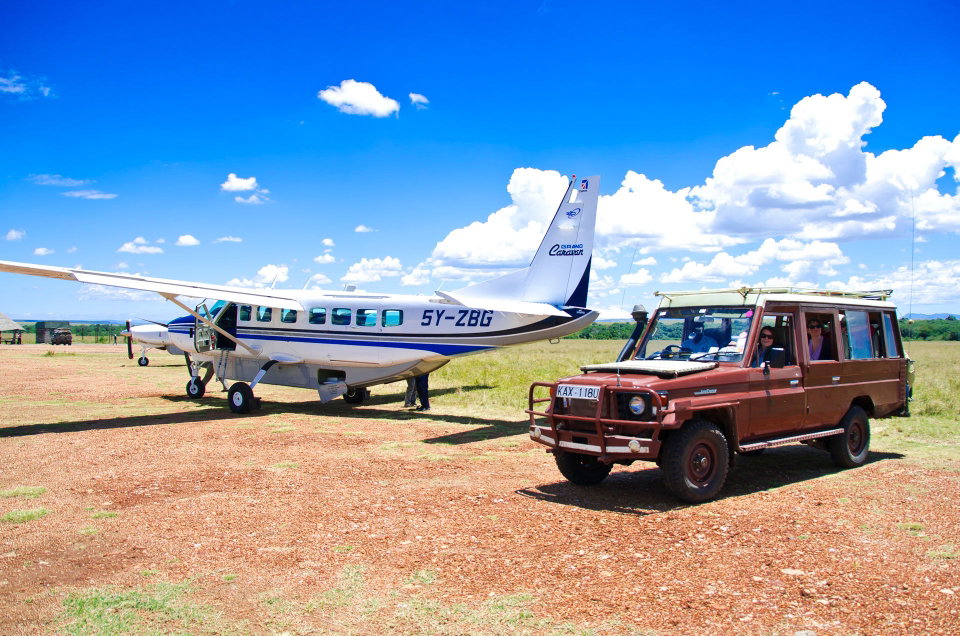 Tour van collecting guests at an airstrip in the Maasai Mara