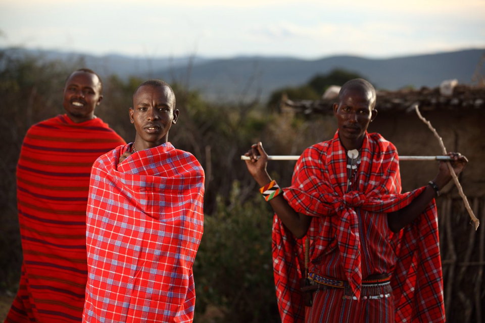 Maasai morans outside a village hut