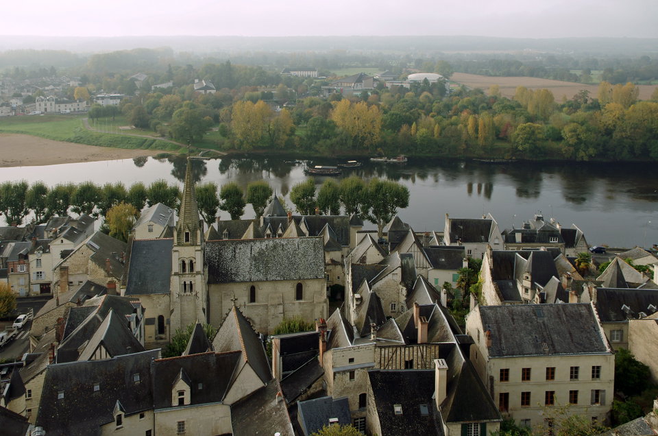 Chinon castle ruins reflected in the Vienne River at golden hour, Loire Valley, France