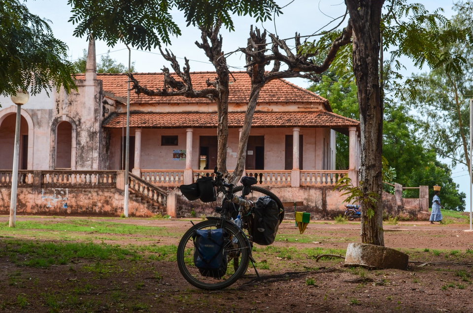 Colorful colonial buildings and fishing boats along the Geba River waterfront in Bissau, Guinea-Bissau