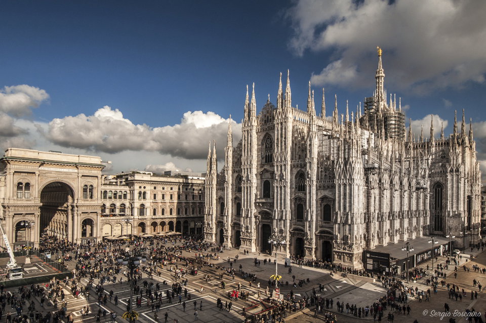Milan's Duomo cathedral glowing at dusk with the Galleria Vittorio Emanuele II arcade in the background