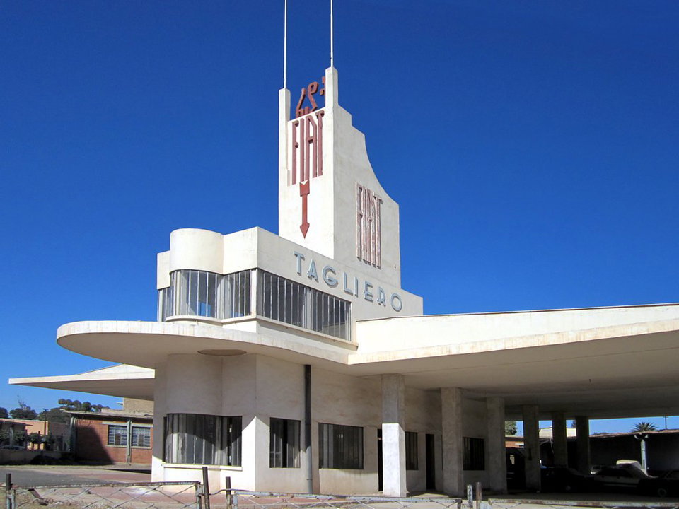 Asmara's Fiat Tagliero Building and tree-lined avenue at golden hour, Eritrea