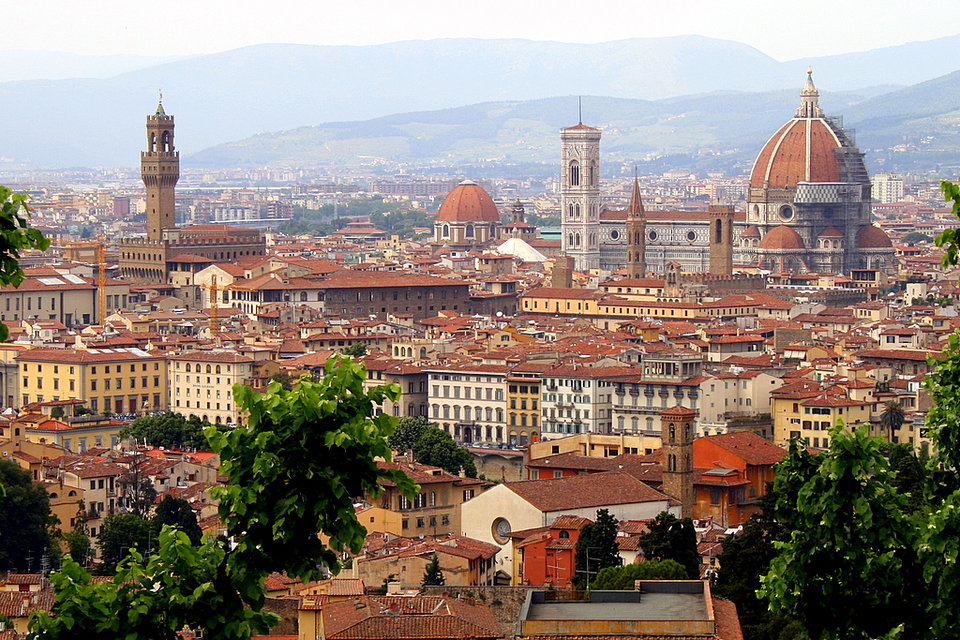 Panoramic view of Florence's terracotta rooftops and the iconic dome of the Cathedral of Santa Maria del Fiore at golden hour