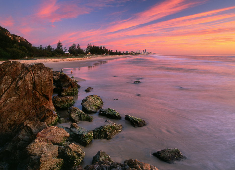Surfers Paradise skyline rising behind golden beach and rolling surf, Gold Coast, Queensland
