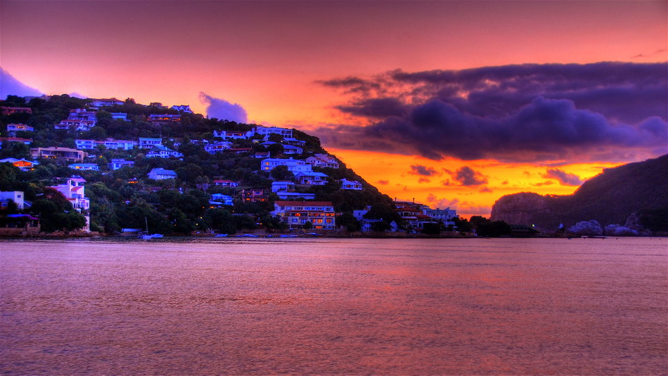 Knysna Lagoon at golden hour with the iconic Heads rock formations framing the Indian Ocean beyond