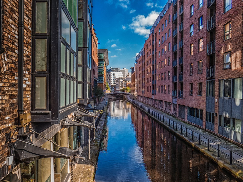 Manchester city skyline at dusk with Beetham Tower and the River Irwell reflecting city lights