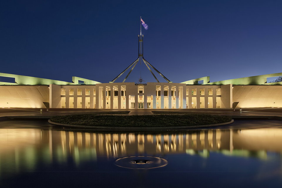 Aerial view of Canberra with Lake Burley Griffin in the foreground and Parliament House on Capitol Hill beyond