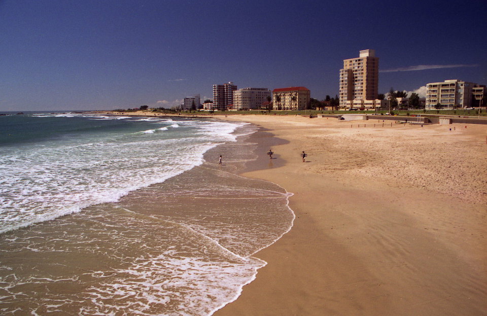 Aerial view of Port Elizabeth coastline with golden beaches and the city skyline at sunset