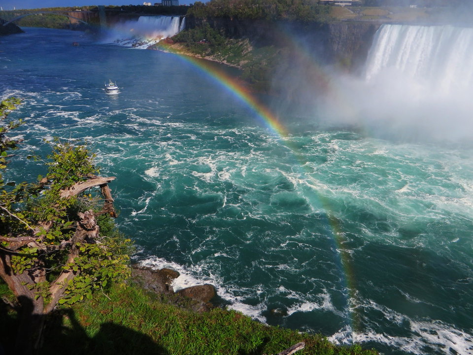 Horseshoe Falls at Niagara illuminated at dusk, mist rising over the churning green water