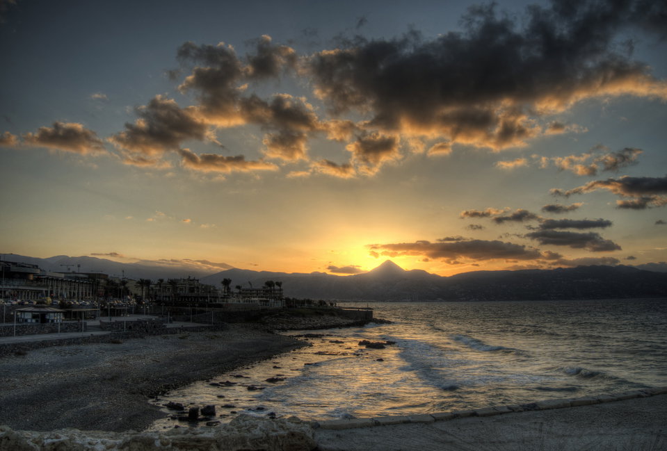 Venetian harbour fortress of Koules at sunset with fishing boats moored in Heraklion, Crete