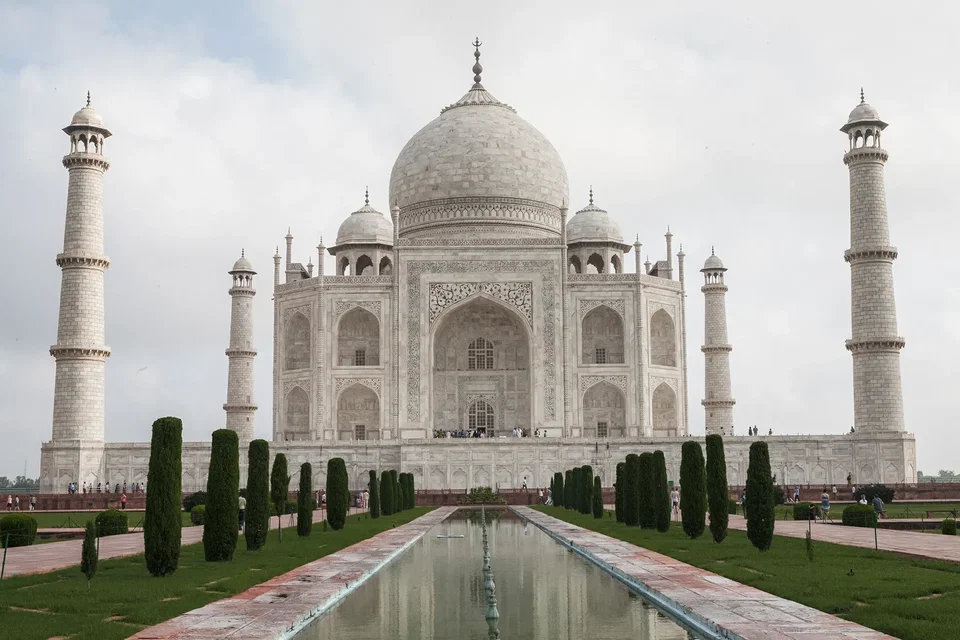 The Taj Mahal at sunrise reflected in the Yamuna River, Agra, India
