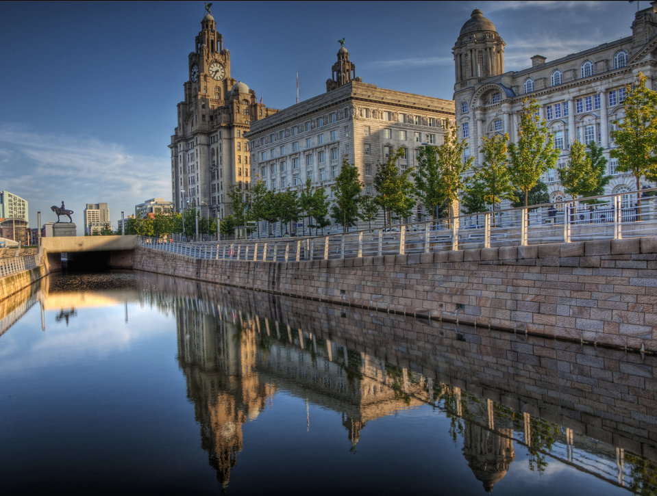 Liverpool waterfront at dusk with the Three Graces reflected in the River Mersey
