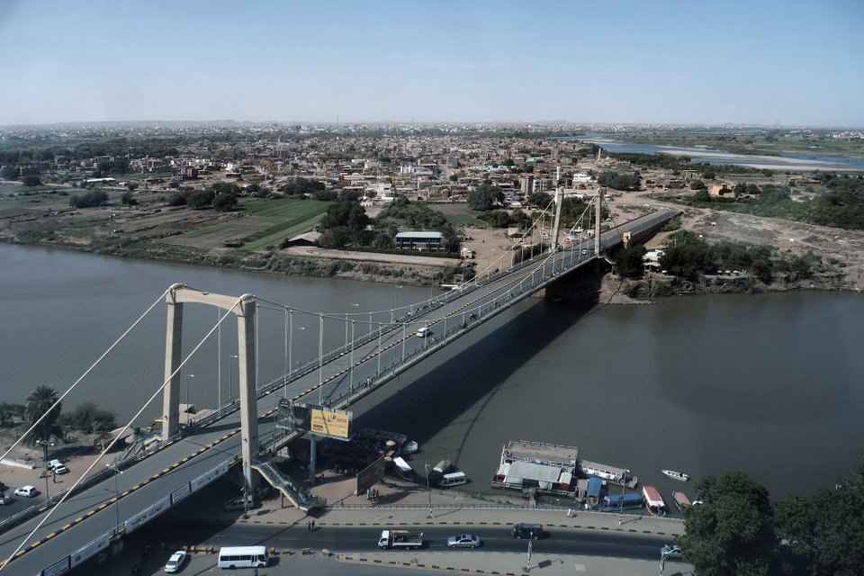 The confluence of the Blue and White Nile rivers at Khartoum at sunset, with the city skyline in the background