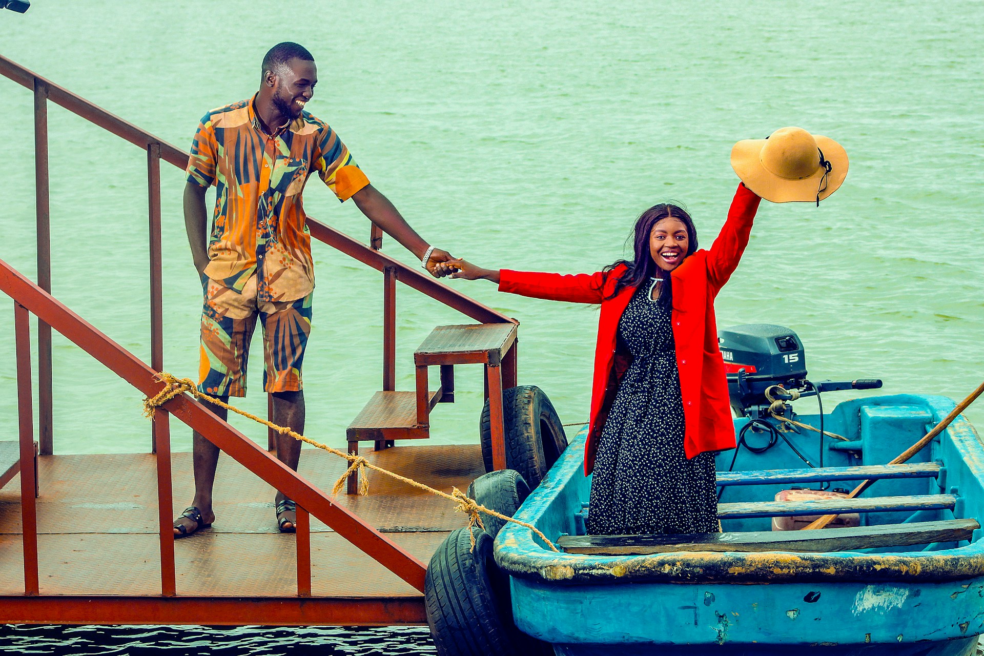A happy, modern couple arrive at a boat pier in Jos, Nigeria. Photo by Chidy Young.
