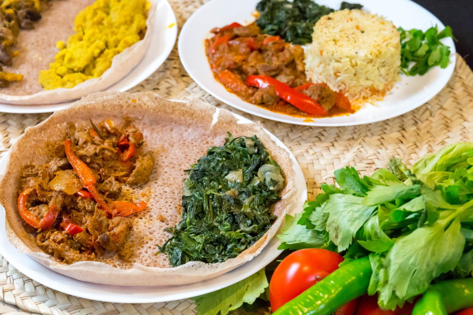 Injera (Ethiopian flatbread) with beef and spinach. Photo by Marco Verch.