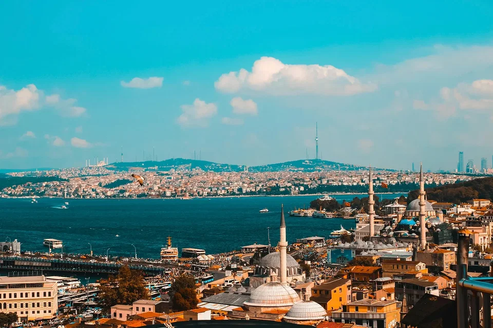 Istanbul skyline at dusk with the Bosphorus, minarets, and the Hagia Sophia glowing against a golden sky