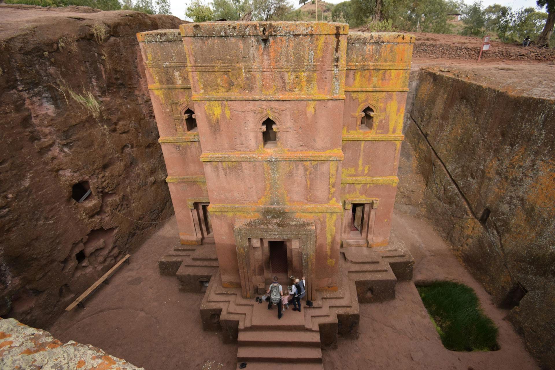 Visitors enter one of the rock churches of Lalibela in Ethiopia