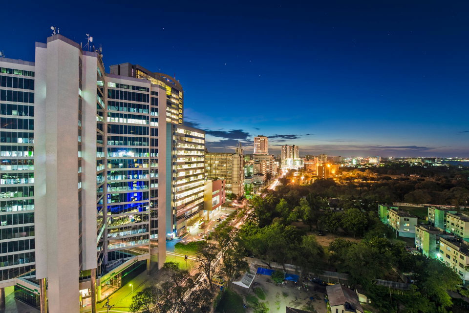 Aerial shot of lighted buildings in Dar es Salaam, Tanzania at night. Photo by Keegan Checks.