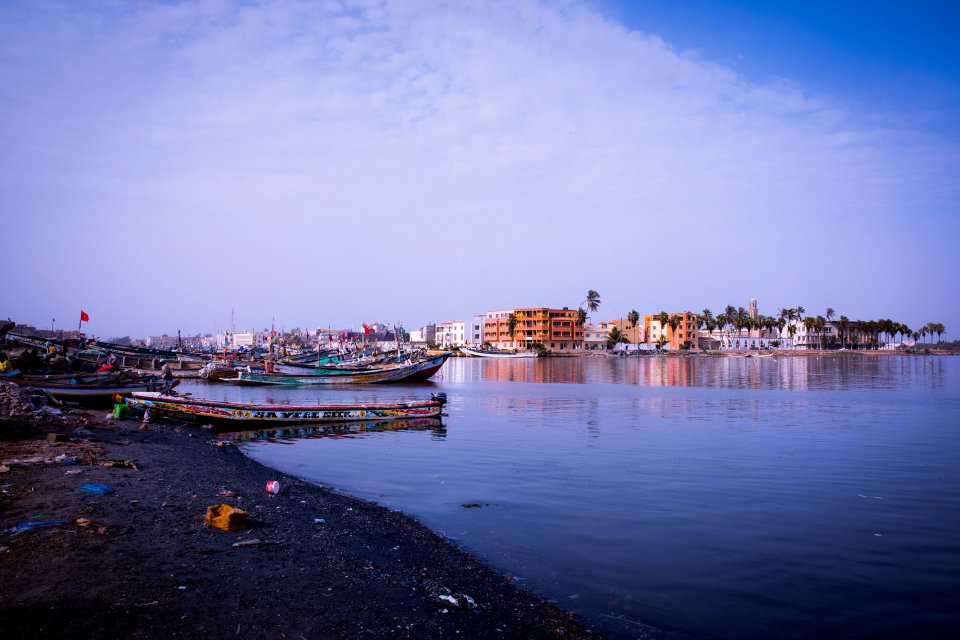 Dakar skyline at sunset with fishing pirogues on the Atlantic coast