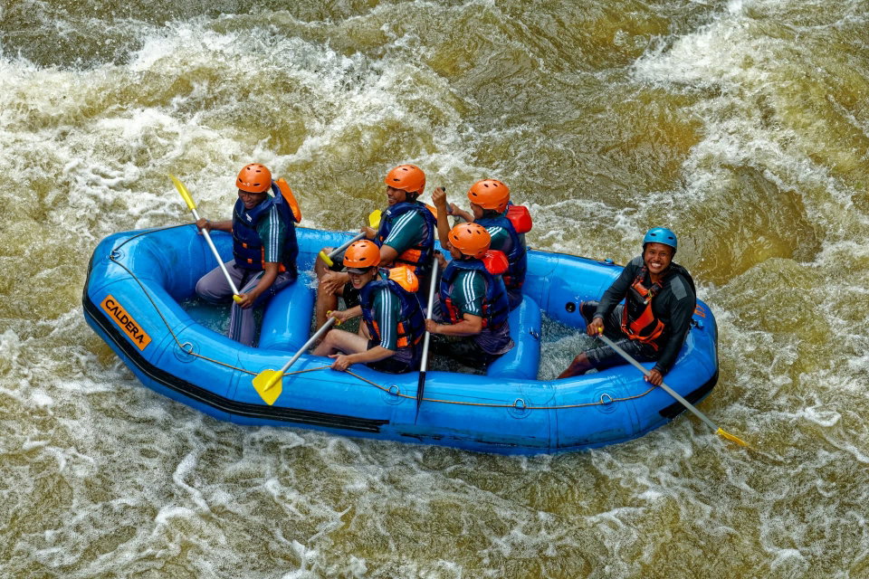 Tourists enjoy a white water raft on a rapid river