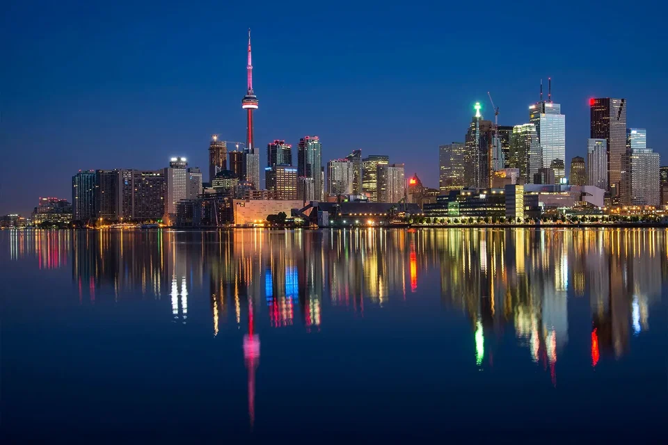 Toronto skyline at dusk with the CN Tower reflected in Lake Ontario